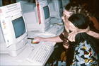 APC WNSP media trainer showing woman from Africa how to send emails and access the internet, International Women's Tribune Centre Slide Show, NGO Forum, Huairou, China 30 August – 8 September, 1995