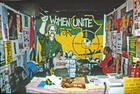 South Africa booth: Banner behind saying WOMEN UNITE, International Women's Tribune Centre Slide Show, NGO Forum, Huairou, China 30 August – 8 September, 1995