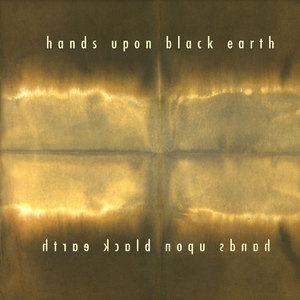 hands upon black earth