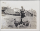 Pair of Drums Being Played by a Male Near Village
