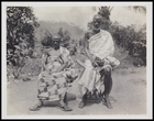 2 male elders, both seated and wearing beards and bodycloths and sandals