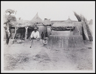 2 males, 2 children, huts in compound