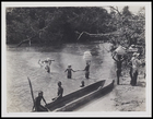[4 people crossing ford, 2 carrying supplies on heads, 3 people on the bank and 3 sitting on a wooden dugout boat