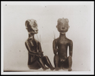 2 figurines, a male and female seated