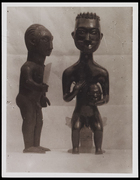 2 standing male figurines, 1 holding a head