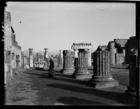 European woman looking at ruins of columns