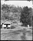 small hut in grounds of LMS Misison House, other huts and gardens behind