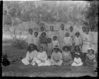 group of men, women and children, including Rarotongan children of LMS South Seas techers, all wearing European clothing, in grounds of London Missionary Society Mission House