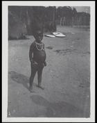 child standing near hut