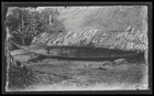A canoe leaning against a dwelling, at Rubiana Lagoon, New Georgia Island.