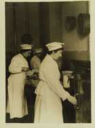 Photograph of cooks preparing food in a communal kitchen