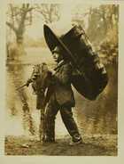 Photograph of a fisherman carrying his equipment