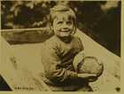 Photograph of a young Belgian refugee holding a loaf of bread