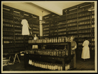 Photograph  of women in room of shelves of jarred food
