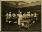 Photograph of women preparing food in jars