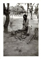 Black and White photograph: Fideli prepares the medicine basket