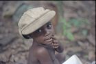 Close-up of a child wearing a cap and looking at the camera.